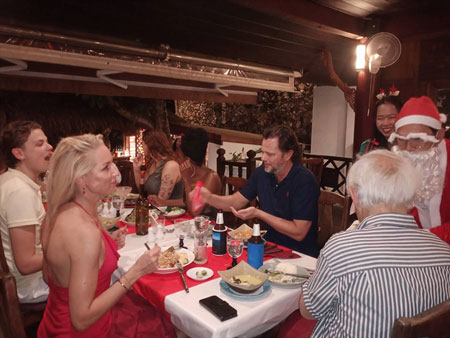 Santa giving guests gifts at Anavana restaurant