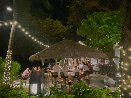 Guests Sitting & Drinking At Anavana Beachside Bar