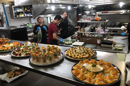 happy kitchen staff prepairing starters at Anavana Beachside Restaurant & Bar