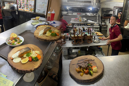 Kitchen Staff Working Hard To Get The Main Courses Out at Anavana Beachside Restaurant & Bar